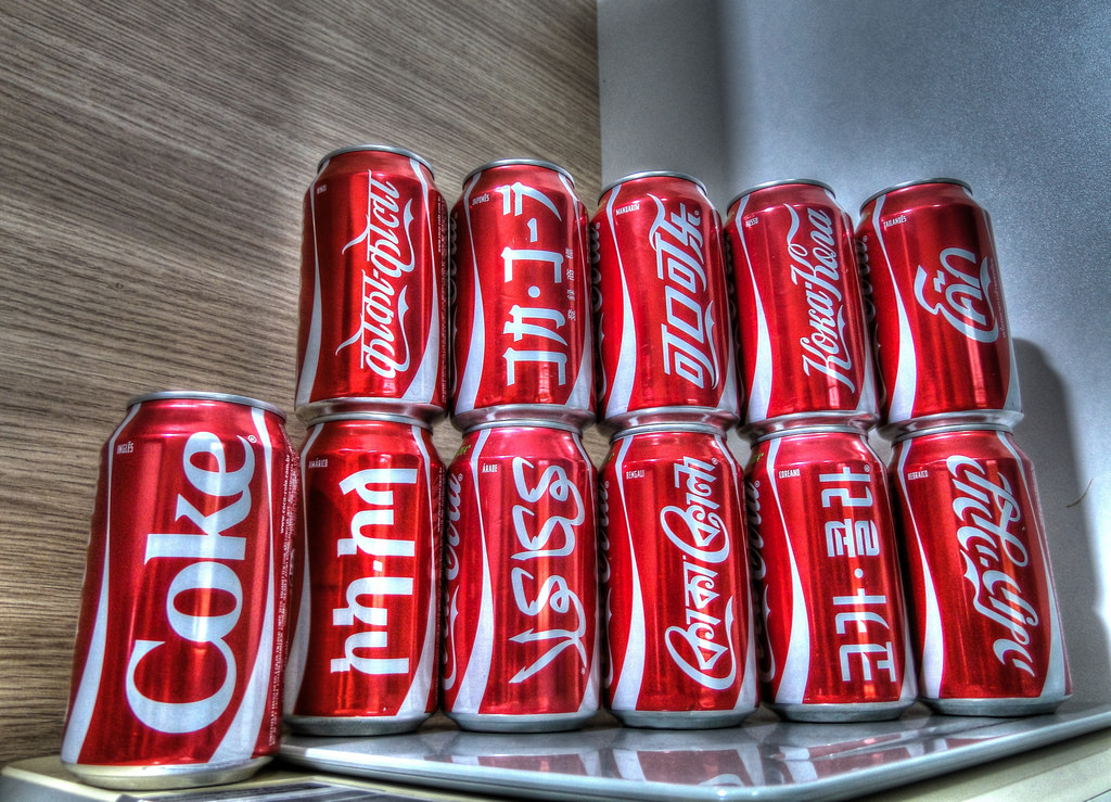 stack of coke cans from around the world