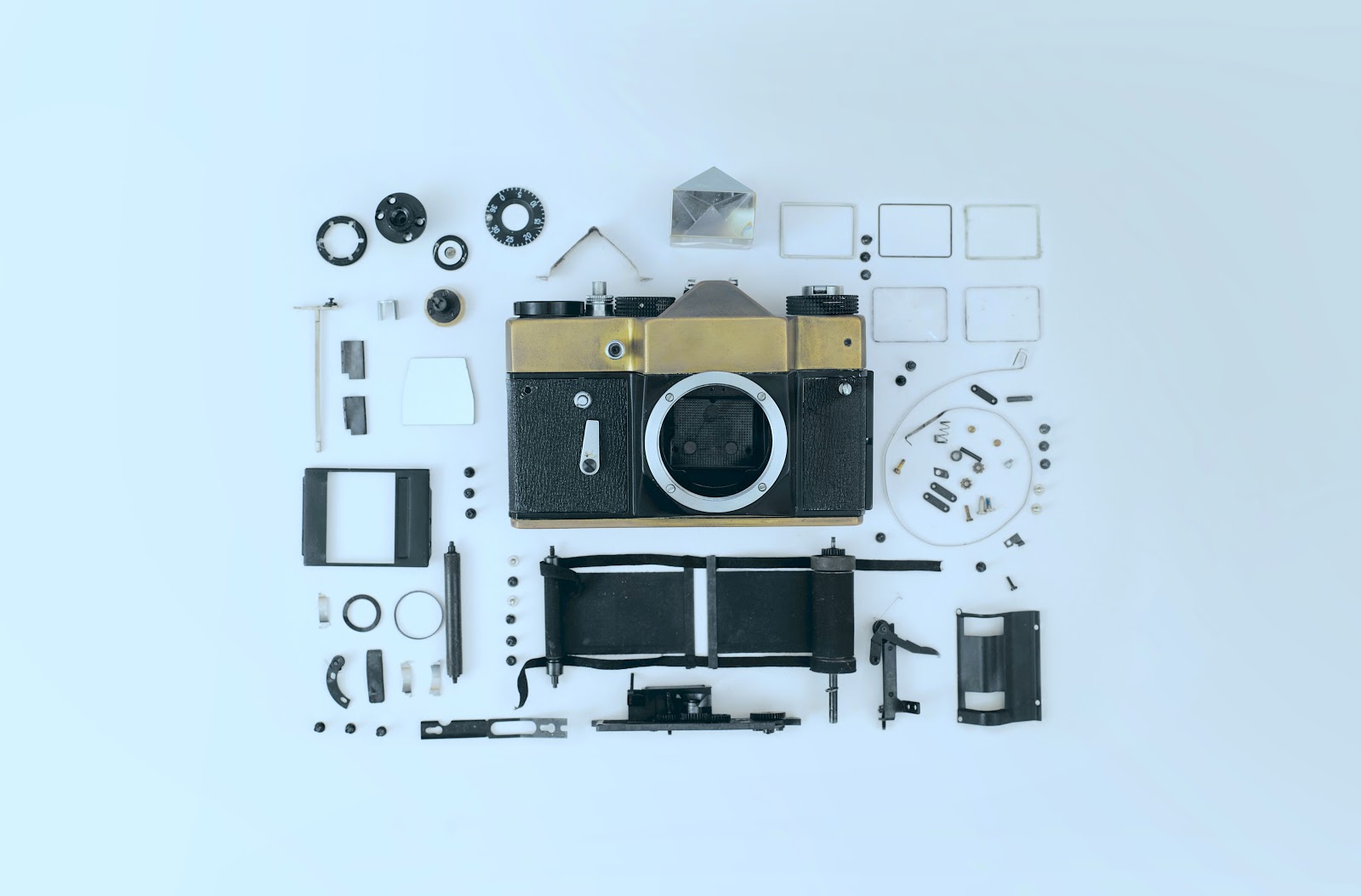 A disassembled single lens reflex camera with all its parts