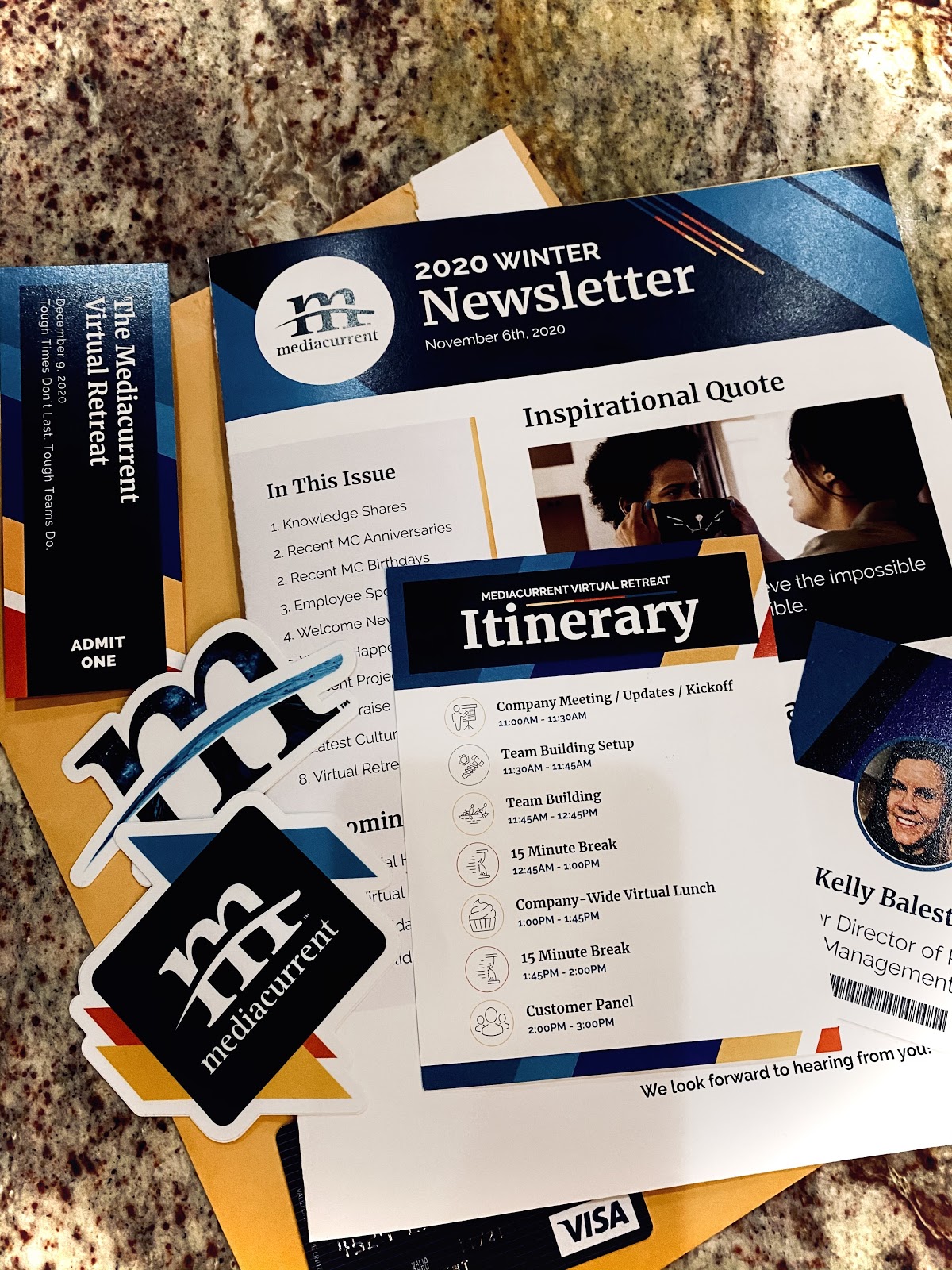 pre-event retreat mailer with Mediacurrent branded print materials, including stickers and a copy of the company newsletter 