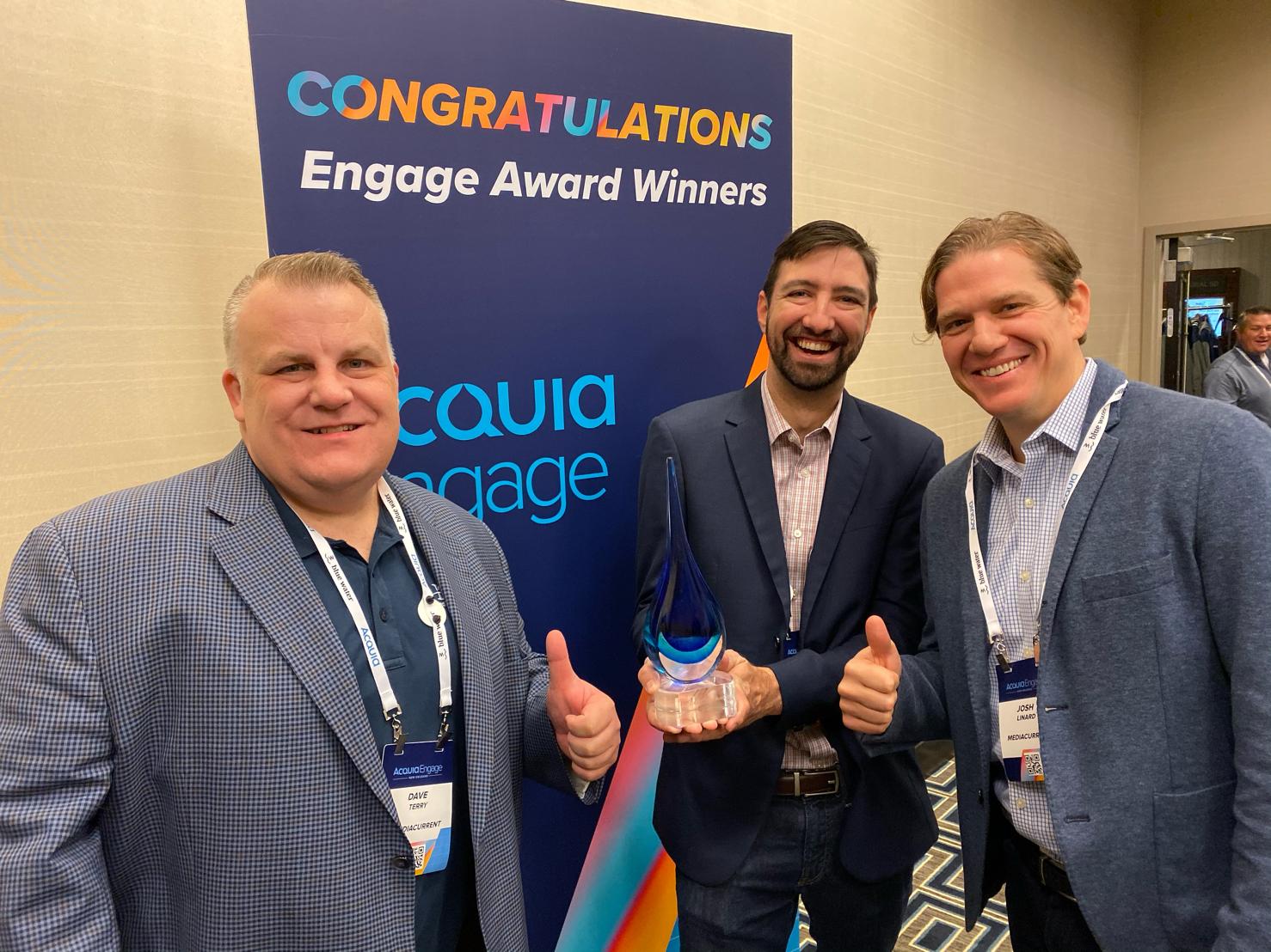 Mediacurrent team holds Acquia Engage Award trophy in 2019 