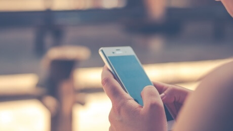 person scrolling through a smartphone screen