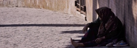 Woman sitting against wall